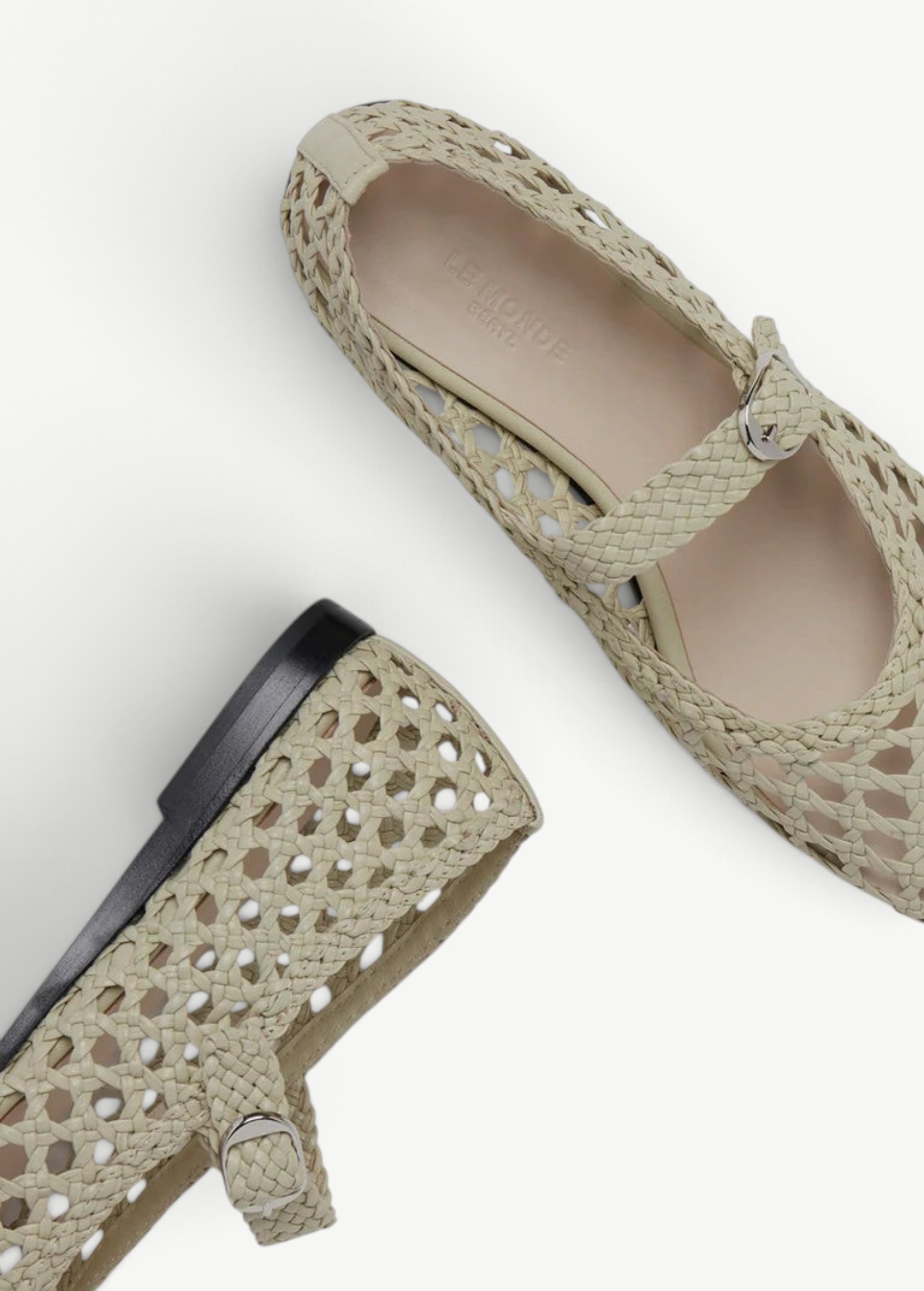 Two Mary Jane Woven Leather Shoes in beige handwoven goatskin are displayed on a white background—one shown from above and the other from the side—showcasing their intricate woven design and delicate buckle fastening on the slim strap.