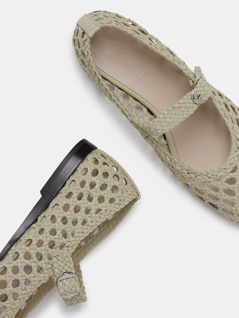 Two Mary Jane Woven Leather Shoes in beige handwoven goatskin are displayed on a white background—one shown from above and the other from the side—showcasing their intricate woven design and delicate buckle fastening on the slim strap.