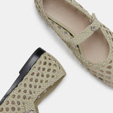 Two Mary Jane Woven Leather Shoes in beige handwoven goatskin are displayed on a white background—one shown from above and the other from the side—showcasing their intricate woven design and delicate buckle fastening on the slim strap.
