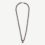 KABE SHOP INC Lark Drip necklace featuring faceted smoky quartz beads and a sculptural gold claw pendant with peridot