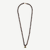 KABE SHOP INC Lark Drip necklace featuring faceted smoky quartz beads and a sculptural gold claw pendant with peridot