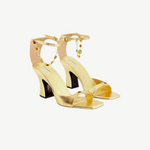 KABE SHOP INC Nodstalgia Gemma gold heeled sandals with jewel-embellished toe straps and colorful ankle charm chains.