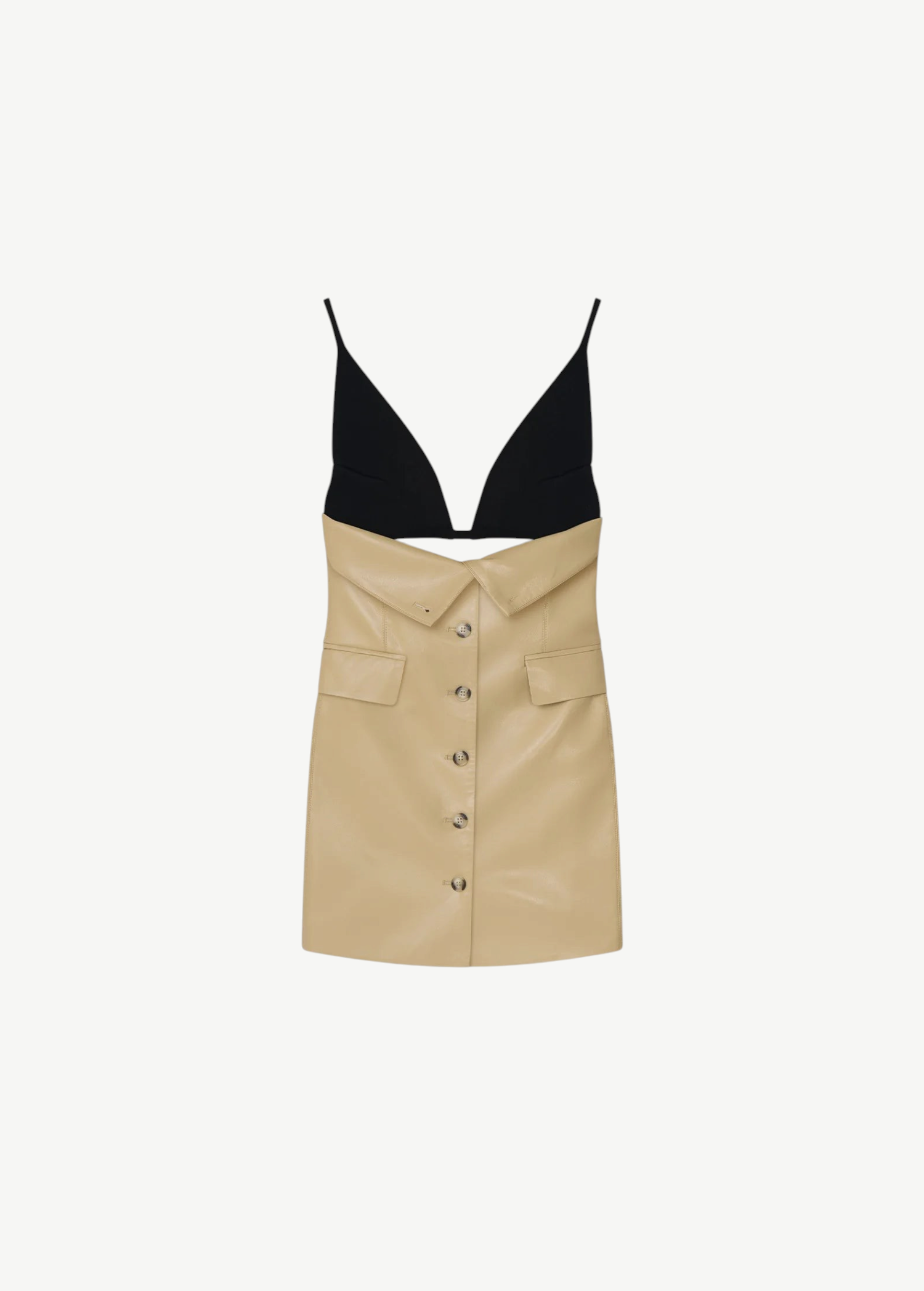 The Zyana Dress is a sleeveless style with a fabric-blocked design, showcasing a black deep V-neck top paired with a beige faux leather skirt featuring a button-down front and flap pockets. The dress is displayed against a plain background.