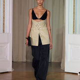 A model walks indoors wearing the Zyana Dress. The background features cream curtains and white paneled walls.