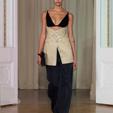 A model walks indoors wearing the Zyana Dress. The background features cream curtains and white paneled walls.