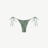 Praia Bottom: A green triangle bikini bottom with a white dotted leaf print, adjustable side ties at the hips, made from recycled nylon and shown against a plain white background.