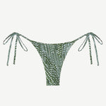 Praia Bottom: A green triangle bikini bottom with a white dotted leaf print, adjustable side ties at the hips, made from recycled nylon and shown against a plain white background.