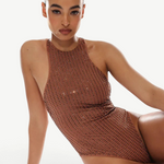 Woman wearing a brown sequin swimsuit on a white background