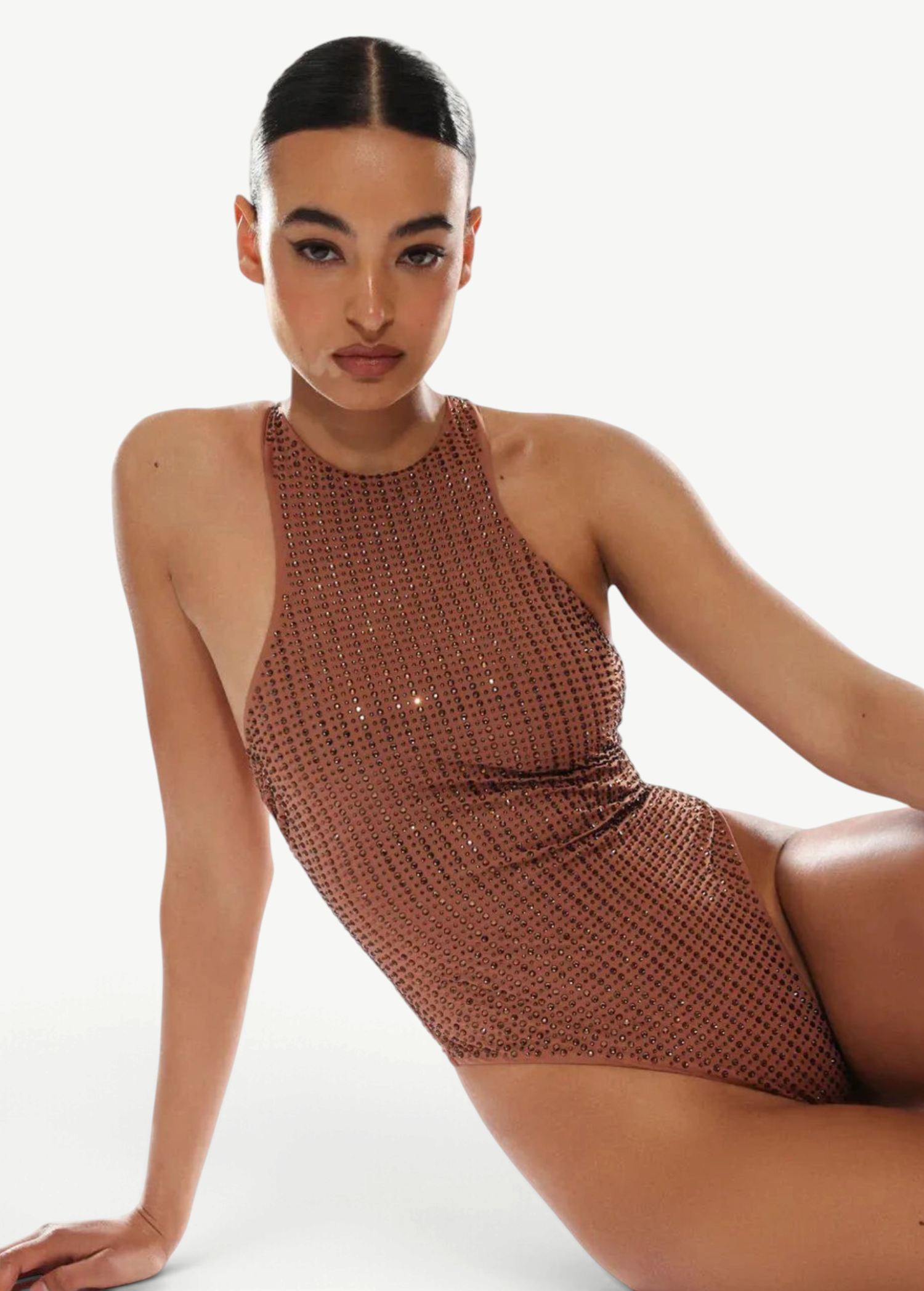 Woman wearing a brown sequin swimsuit on a white background