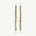 Two vertical strands of round, green marbled beads with wire hooks at each end serve as elegant jewelry straps for the Dolores Top Classic Swimwear, set against a plain light background.