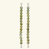 Two vertical strands of round, green marbled beads with wire hooks at each end serve as elegant jewelry straps for the Dolores Top Classic Swimwear, set against a plain light background.
