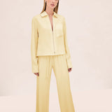 A model wears a light yellow zip-up shirt with matching Damian Pant wide-leg trousers featuring a drawstring waist for a polished style.