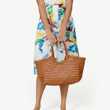 KABE SHOP INC Nantucket Basket Big tote bag in brown handwoven Buffalo Calf leather held by a woman in a floral dress