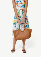 KABE SHOP INC Nantucket Basket Big tote bag in brown handwoven Buffalo Calf leather held by a woman in a floral dress