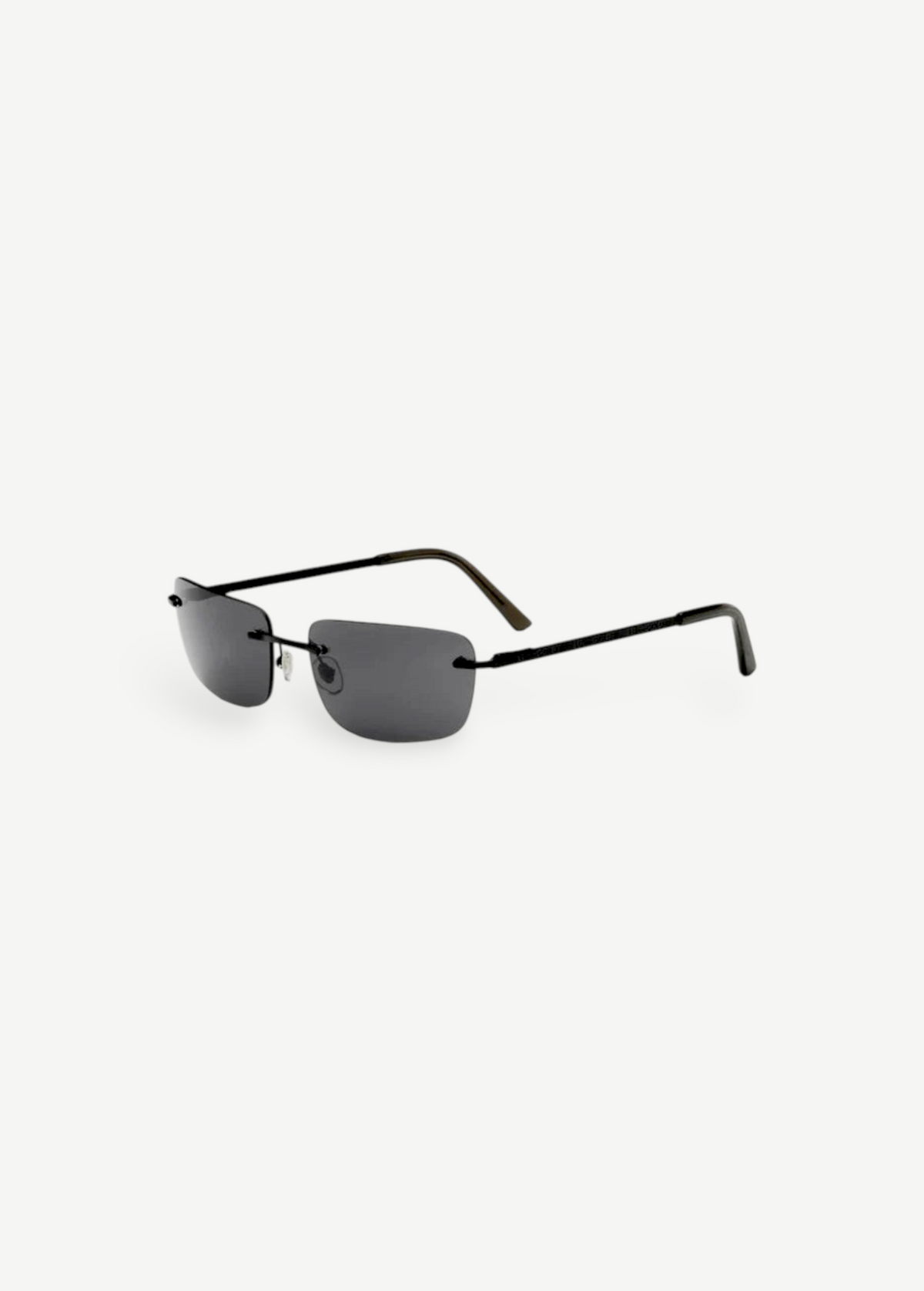 Paris rimless sunglasses feature dark rectangular lenses, thin black metal arms, and black ear tips, delivering a timeless 2000s-inspired style with reliable UV protection, as shown on a plain white background.