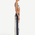 Side profile of a person wearing a bikini top and matching Phillipa Trouser in a vintage floral print with solid navy side panels.