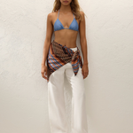 KABE SHOP INC Soleil waist scarf in striped satin worn over white linen trousers and a blue bikini top