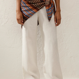 KABE SHOP INC Soleil waist scarf in striped satin tied over white linen trousers on a model