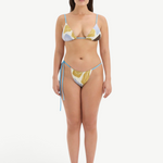 Model wearing KABE SHOP INC Lola string triangle bikini top and matching bottoms in a blue and yellow floral print.
