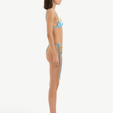 KABE SHOP INC Lola string triangle bikini top in floral print lycra worn by a model in a side profile view