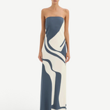 Model wearing KABE SHOP INC Lilou strapless silk midi dress with blue and cream abstract print and bias-cut fit.