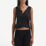 Klara Wrap Top in cotton anglaise featuring a sleeveless silhouette, V-neck, decorative floral embroidery along the edge, and a side tie.