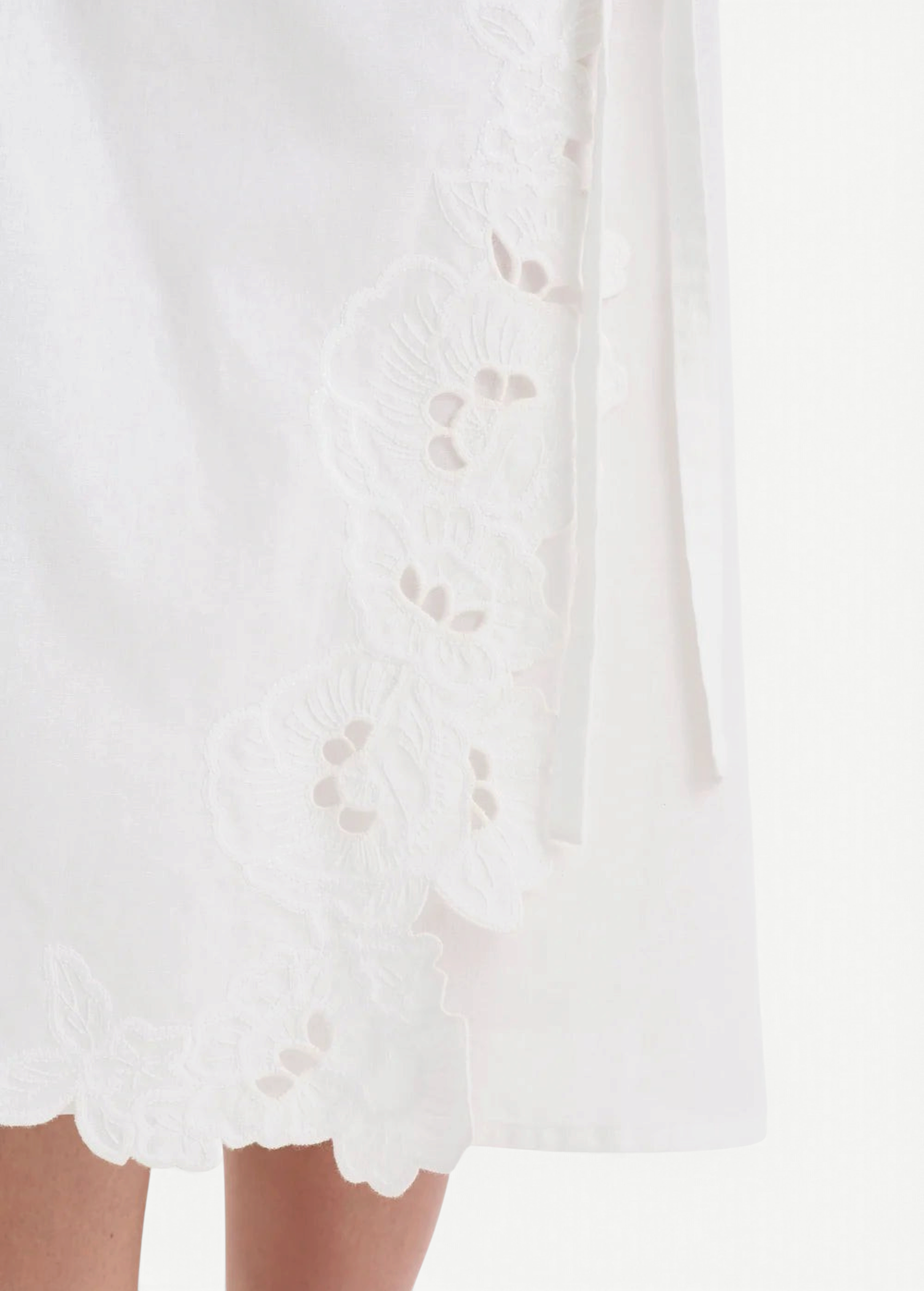KABE SHOP INC Klara midi skirt in white cotton with delicate floral cut-out embroidery and wrap silhouette detail.