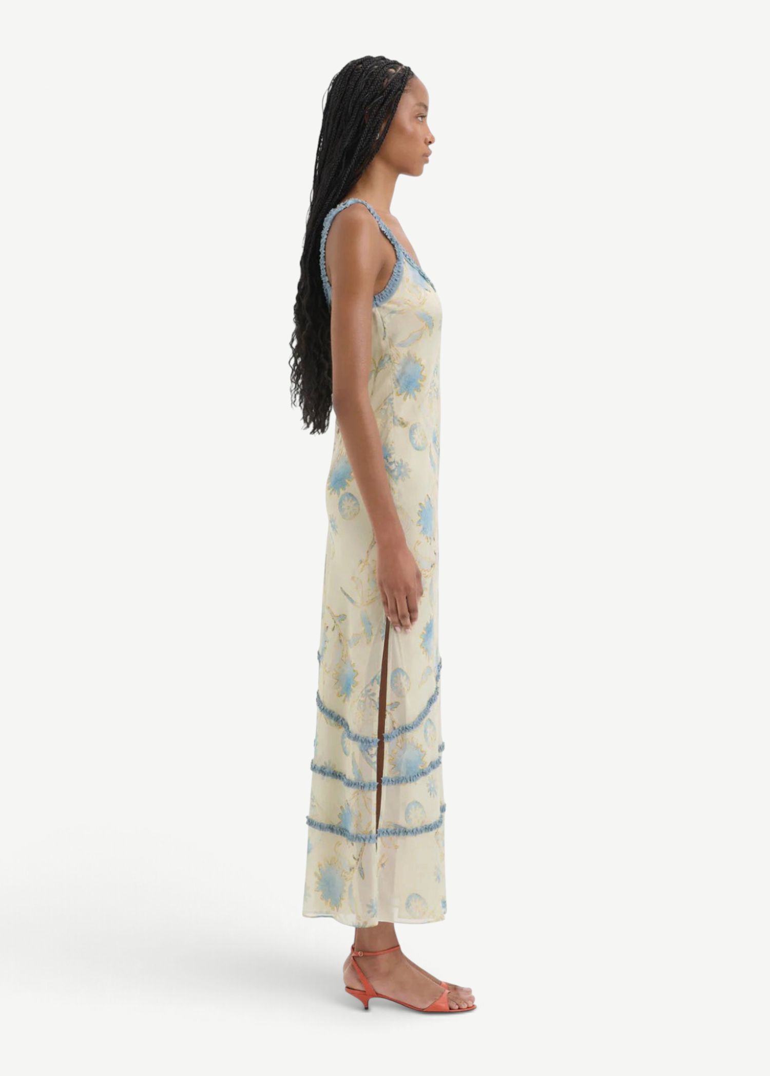 Model wearing KABE SHOP INC Cecile Ruffle Slip Dress in cream with blue floral print and delicate ruffled trim