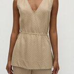 Selan Top in beige, featuring a sleeveless V-neck, relaxed silhouette, drawstring waist, and a diagonal textured pinstripe pattern.