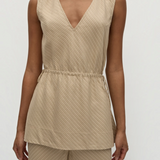 Selan Top in beige, featuring a sleeveless V-neck, relaxed silhouette, drawstring waist, and a diagonal textured pinstripe pattern.