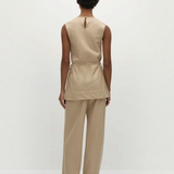 Back view of a person in a Selan Top with a cinched waist and matching wide-leg trousers, both featuring a diagonal pinstripe pattern for a refined, relaxed silhouette.