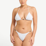 Model wearing KABE SHOP INC white textured bikini with beaded details and adjustable side ties on the Vista Brief