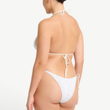 KABE SHOP INC Vista Brief in white with adjustable side ties and delicate beaded details, worn by a model, back view.