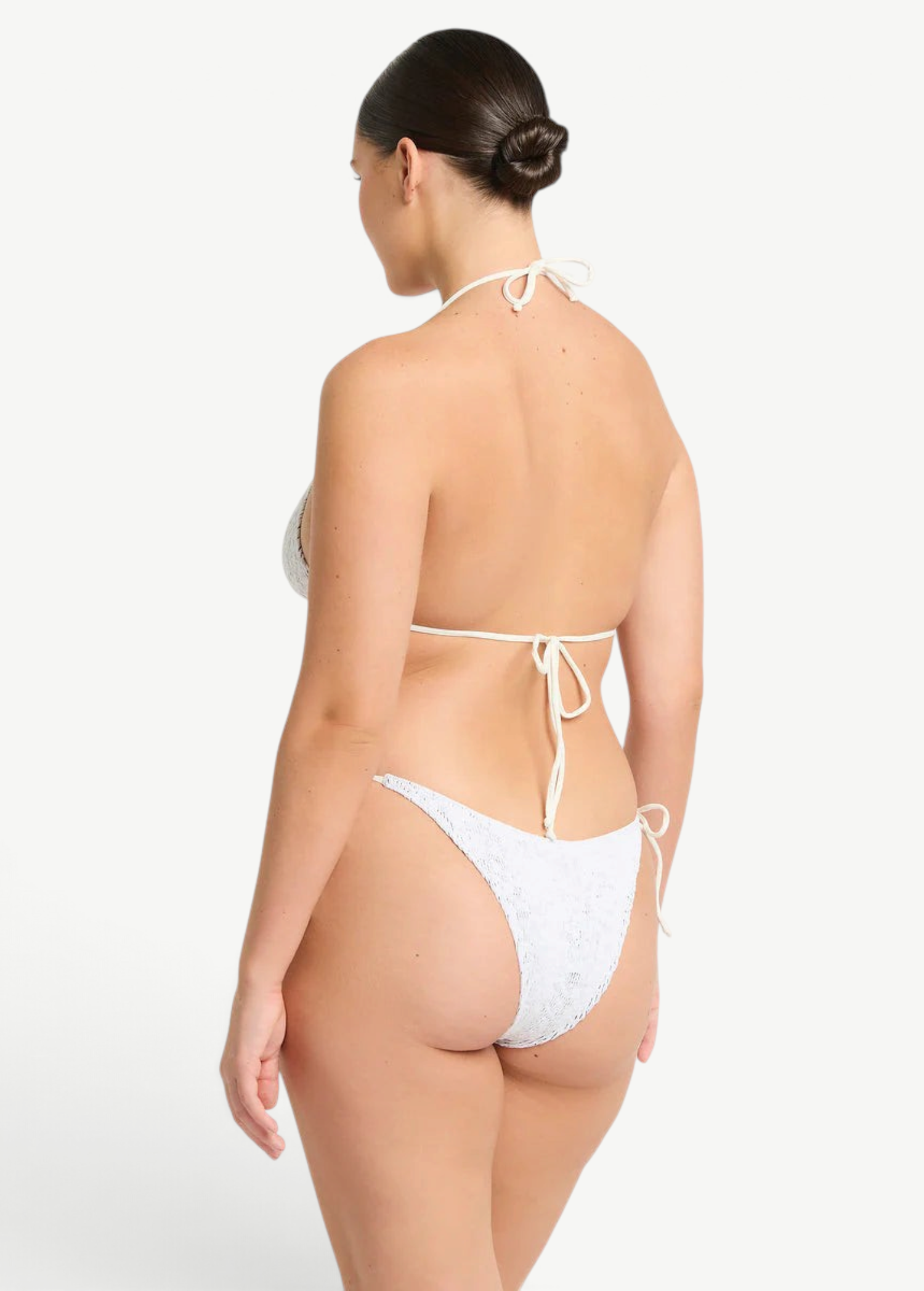 KABE SHOP INC Vista Brief in white with adjustable side ties and delicate beaded details, worn by a model, back view.