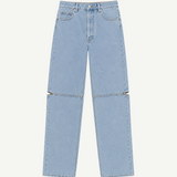 Cowgirl Jeans in light blue denim feature a straight-leg fit, custom hardware, and horizontal zippers at the knees that allow you to detach the lower legs—instantly transforming them into versatile shorts ideal for both horseback riding and everyday wear.