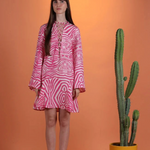 Model wearing a KABE SHOP INC Poccaa short kaftan with a pink and white zebra print and lace-up neckline