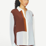 Model wearing a KABE SHOP INC Marais silk shirt featuring a fluid, colour-blocked design in brown, white, and light blue.