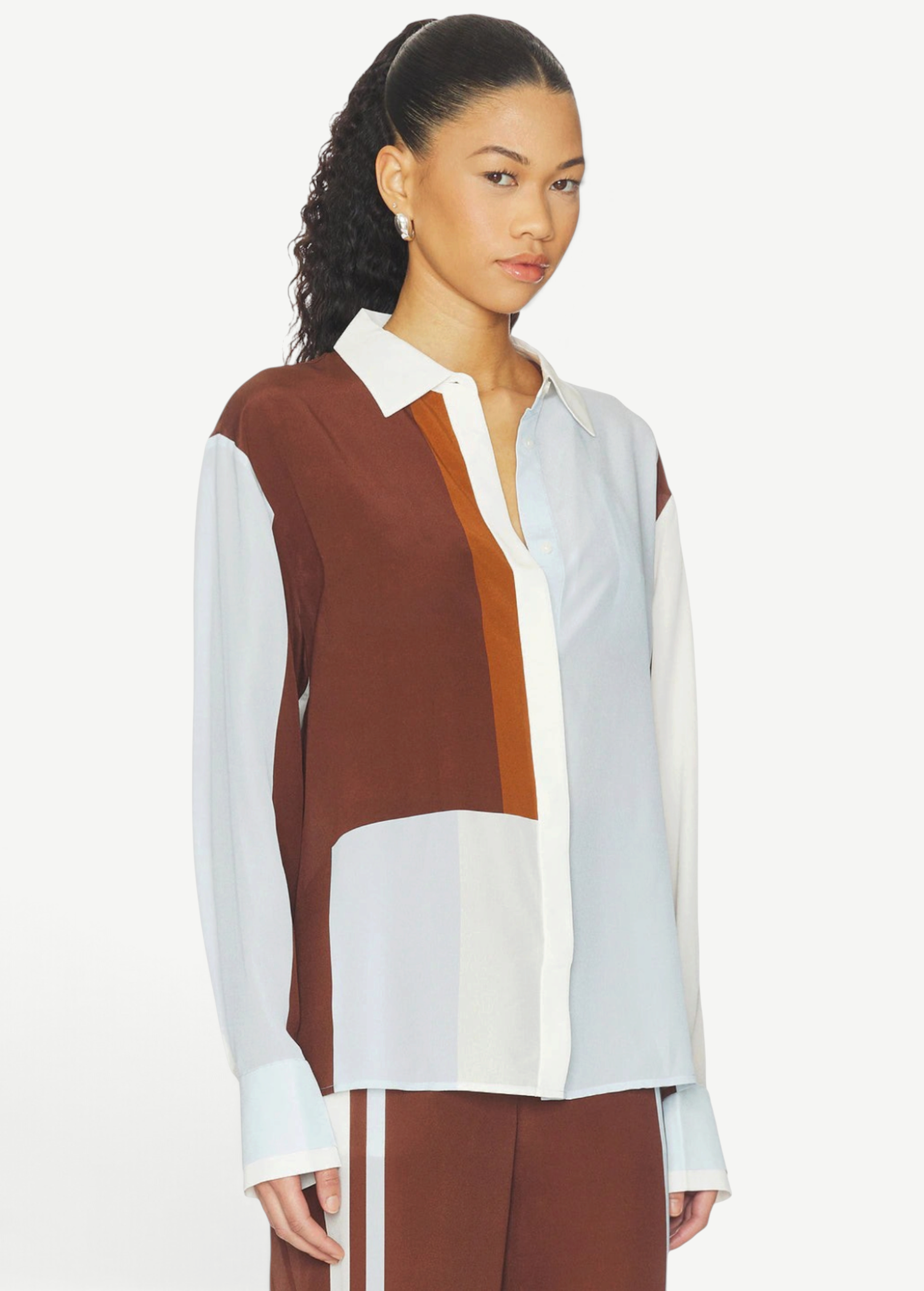 Model wearing a KABE SHOP INC Marais silk shirt featuring a fluid, colour-blocked design in brown, white, and light blue.