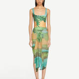 KABE SHOP INC Magdalena Pareo featuring a fluid landscape print in green and orange, worn as a wrap skirt.