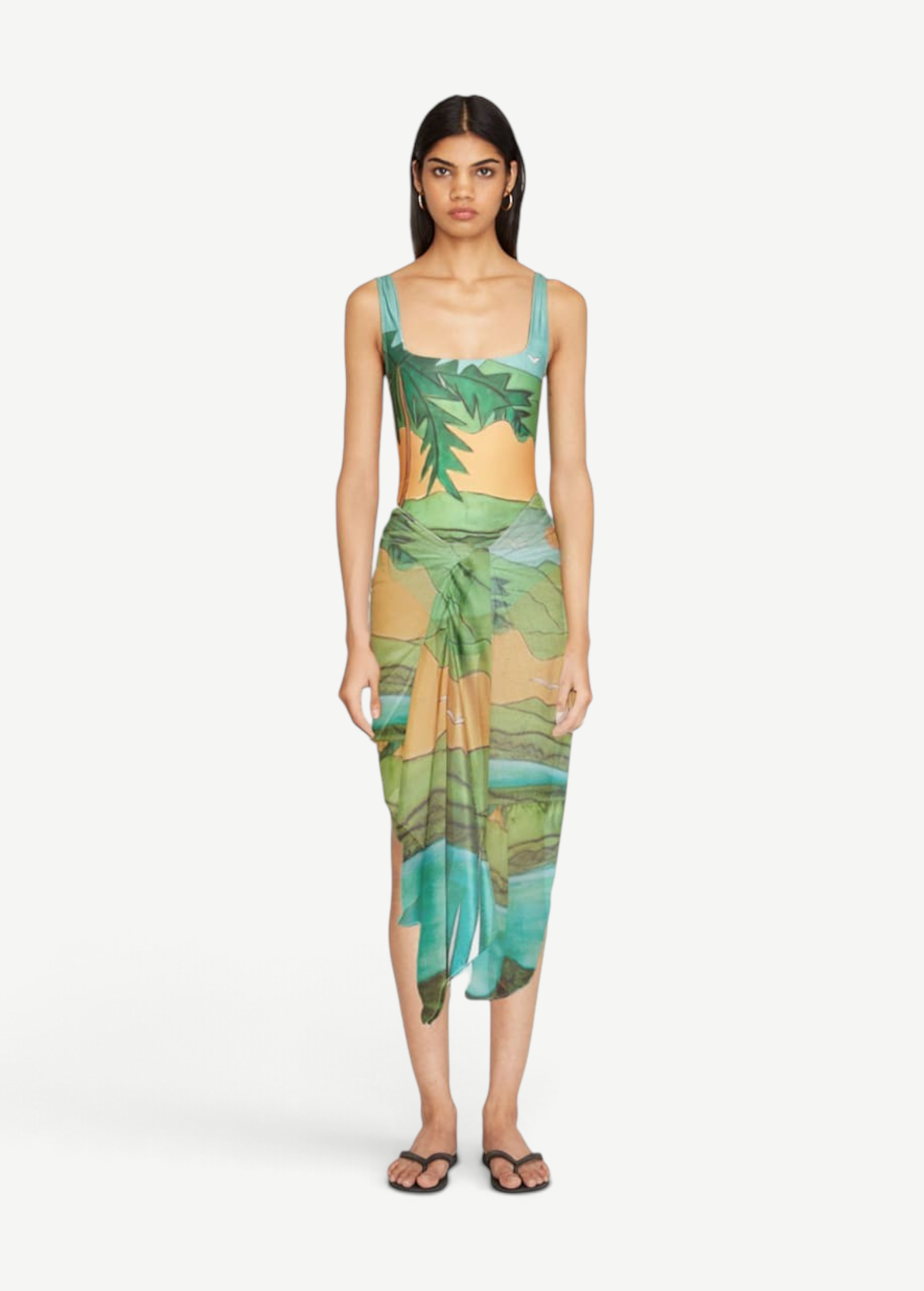 KABE SHOP INC Magdalena Pareo featuring a fluid landscape print in green and orange, worn as a wrap skirt.