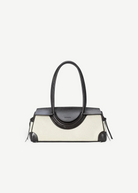 KABE SHOP INC Maude shoulder bag featuring a structured cream canvas body with dark brown leather trim and handles.
