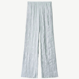 Light blue Nami Pant wide-leg trousers featuring a vertical crinkled texture and an elastic waistband for a relaxed silhouette.