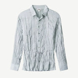 Light blue long-sleeved Suki Shirt with a crinkled texture and a thin drawstring waist tie.