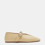 A pair of Stella Slipper Leather Shoes in custard leather, designed in a beige hue with a flat sole, pointed toe, and an elegant buckle. A single silver strap crosses the instep, displayed on a white background.