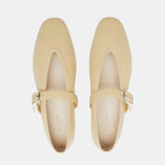 Beige Stella Slipper Leather Shoes, crafted from soft custard leather with square toes and an elegant buckle on the straps, are shown from above on a white background. These shoes offer timeless charm and refined detail.