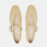 Beige Stella Slipper Leather Shoes, crafted from soft custard leather with square toes and an elegant buckle on the straps, are shown from above on a white background. These shoes offer timeless charm and refined detail.