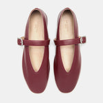 A pair of Stella Slipper Leather Shoes in rouge leather with polished silver buckles, shown from above on a white background.