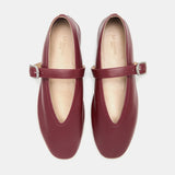 A pair of Stella Slipper Leather Shoes in rouge leather with polished silver buckles, shown from above on a white background.