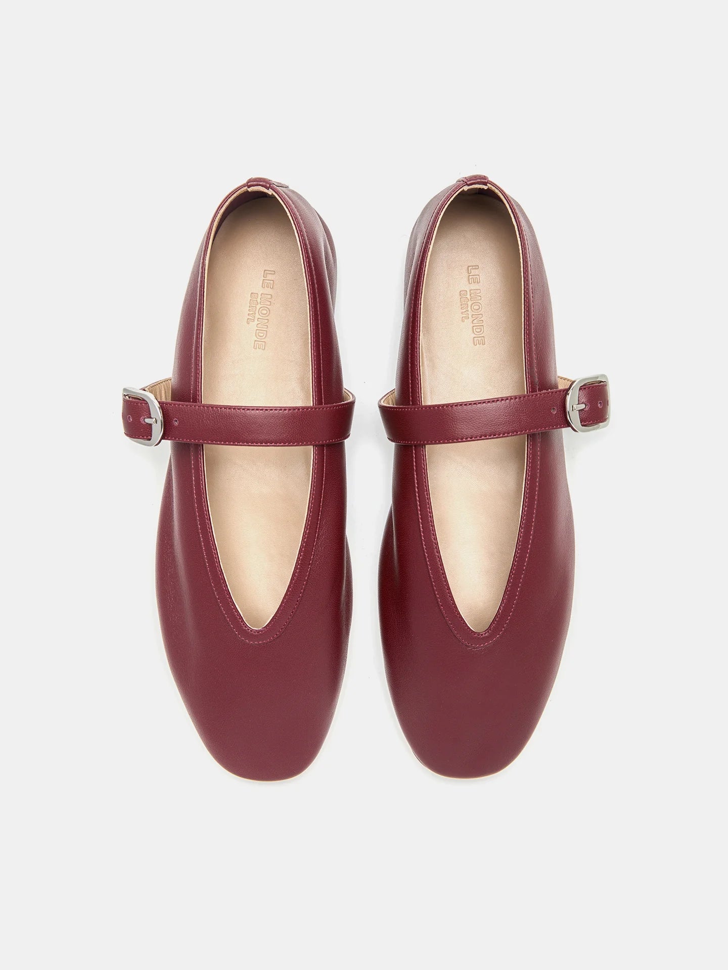 A pair of Stella Slipper Leather Shoes in rouge leather with polished silver buckles, shown from above on a white background.