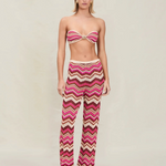 Model wearing KABE SHOP INC Cierra knit pants featuring a pink, brown, and cream chevron pattern with elastic waist.